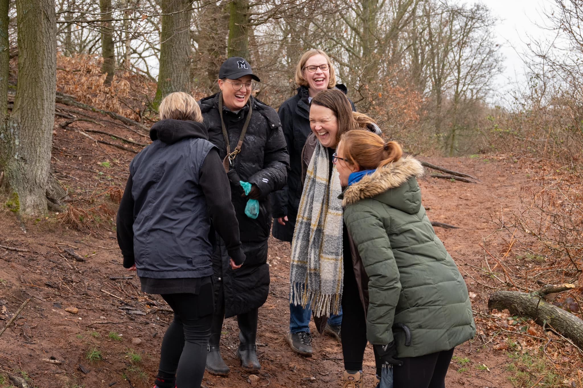 Five ladies laughing whilst networking in nature